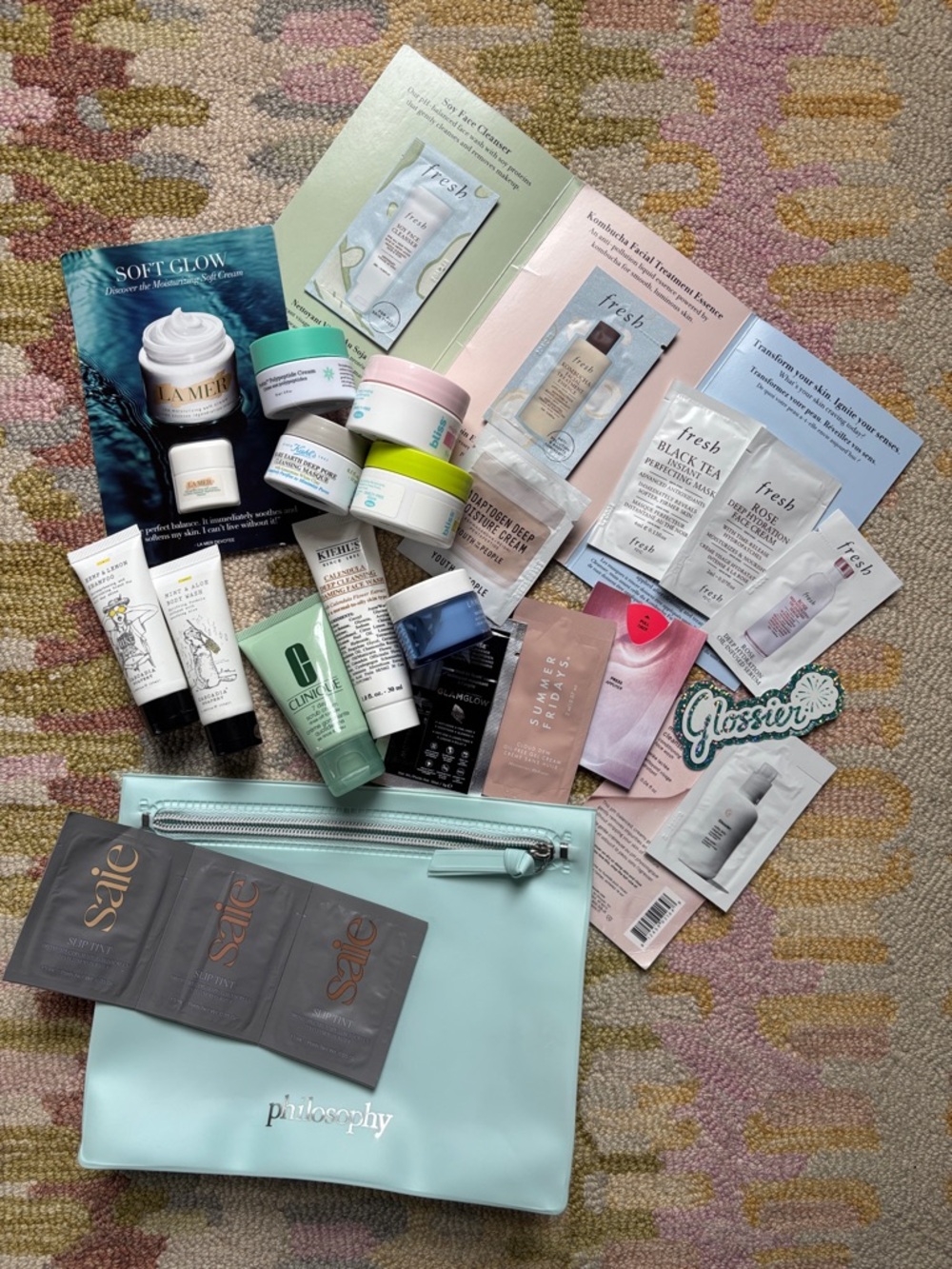 24-Pc Skin Essentials in a Soft textured pastel blue green Philosophy MakeUp bag